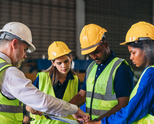Team Engineers And Foreman Stack Hand And Shake Hands To Show Success